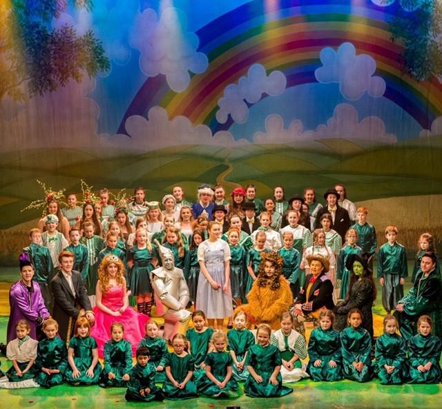 Children dressed as Wizard of Oz characters on a stage.