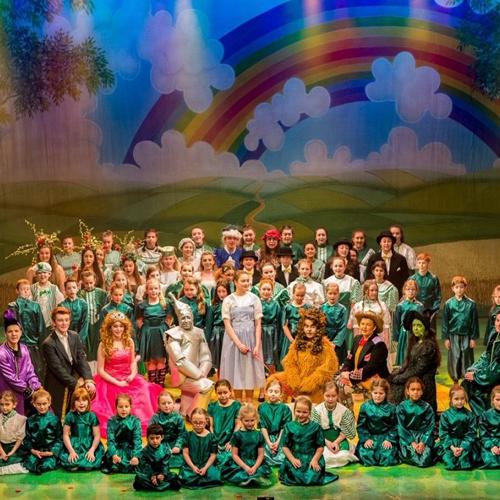 Children dressed as Wizard of Oz characters on a stage.